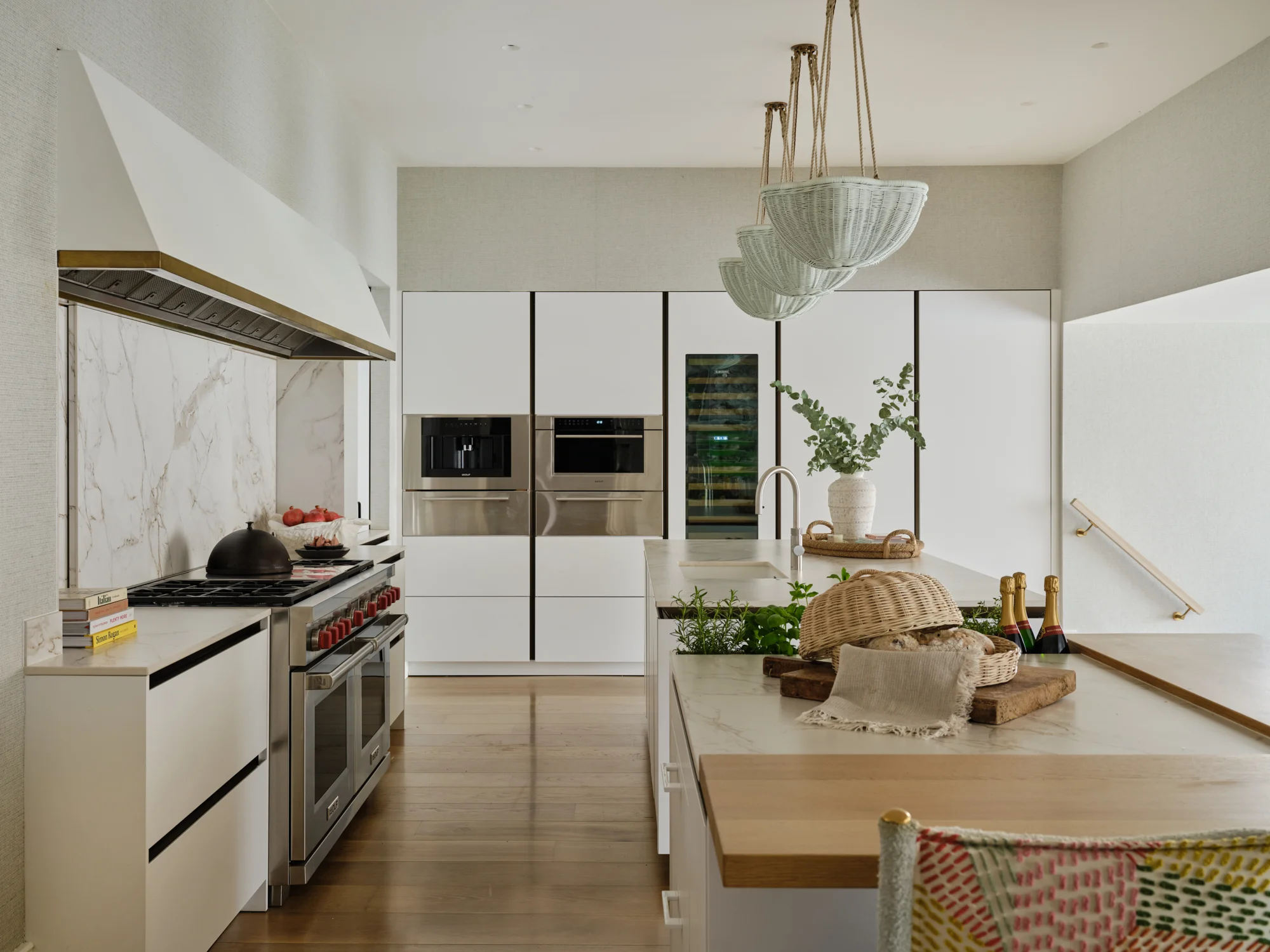 Bespoke kitchen with high end appliances and two large islands with extensive storage and seating, designed by luxury interior design studio Wilding 